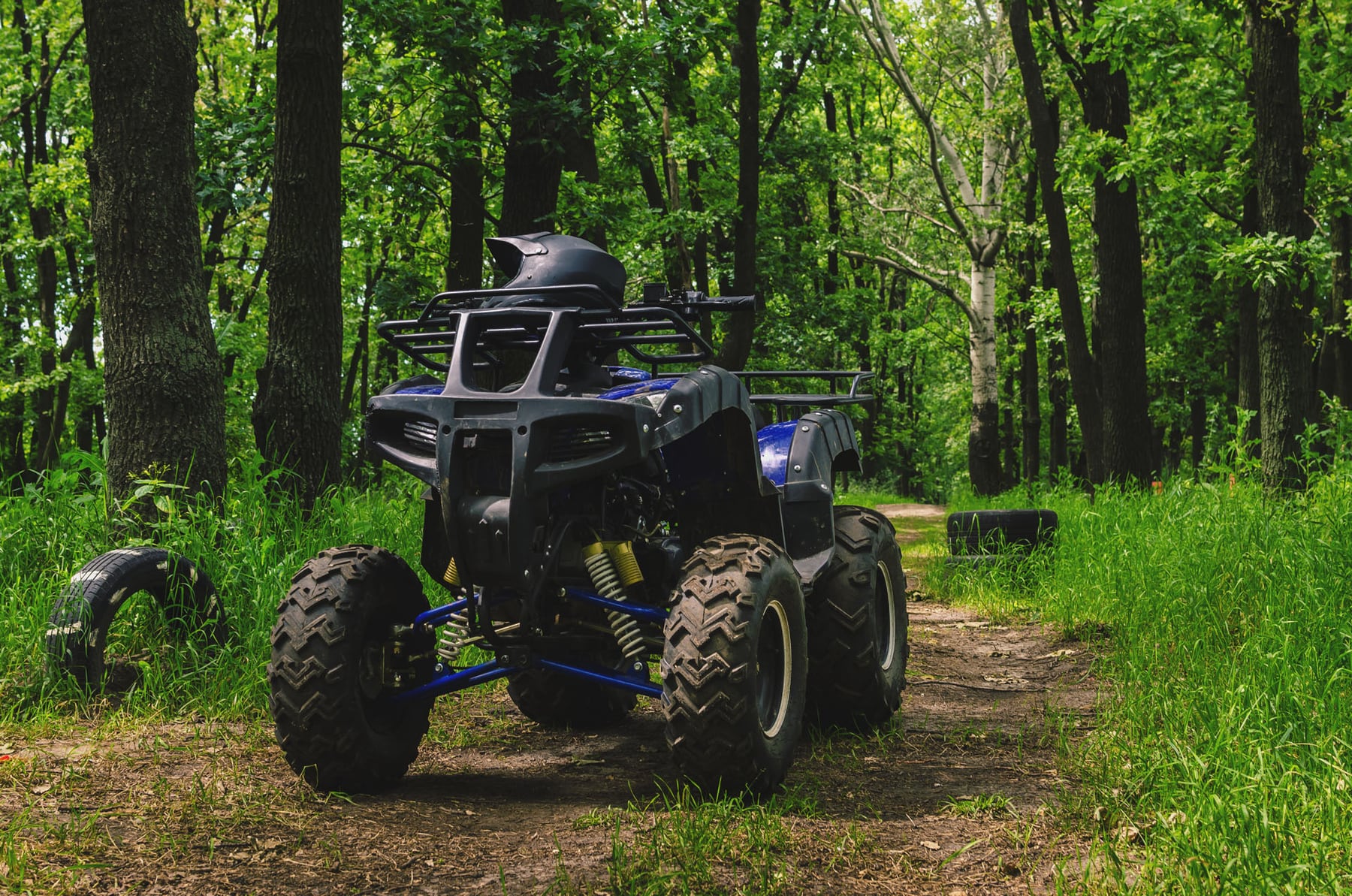 ATV Quad Bike on a special race track in the forest in summer